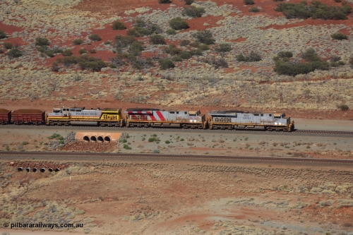 151111 9525
A loaded train behind General Electric ES44DCi units 8113 serial 59105 in the original silver livery and 8145 serial 58726 in the tiger strip Rio livery and Dash 9-44CW 9433 serial 54766 in ROBE Pilbara Iron livery runs over the 54.04 km culvert on the West Mainline bound for Cape Lambert viewed from Table Hill.
Keywords: 8113;GE;ES44DCi;59105;