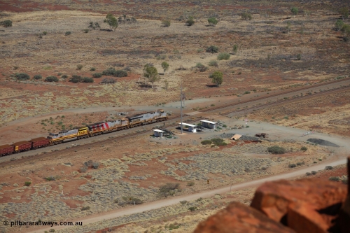 151111 9530
A loaded train behind General Electric ES44DCi units 8113 serial 59105 in the original silver livery and 8145 serial 58726 in the tiger strip Rio livery and Dash 9-44CW 9433 serial 54766 in ROBE Pilbara Iron livery runs along on the West Mainline bound for Cape Lambert viewed from Table Hill.
Keywords: 8113;GE;ES44DCi;59105;