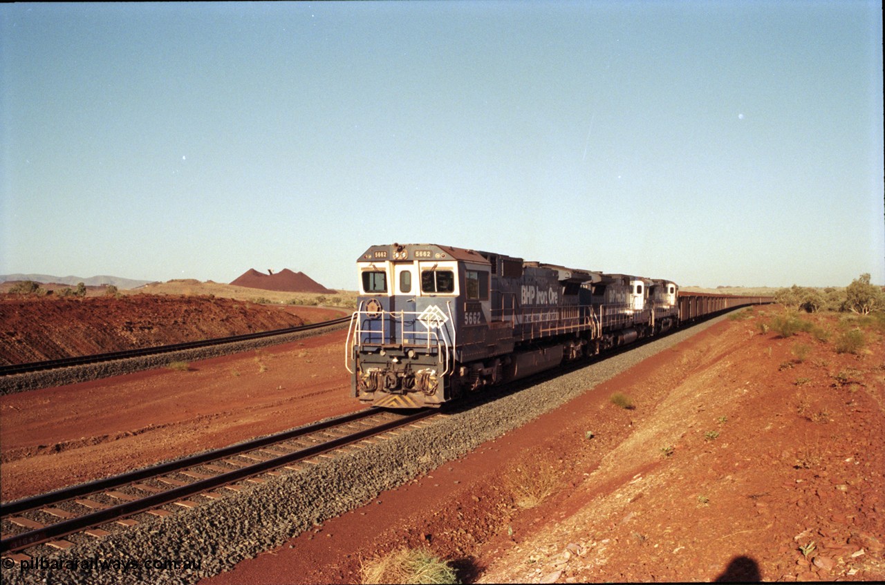 196-15
Yandi Two loaded car side of the loadout balloon loop, loaded train departing behind BHP Iron Ore triple CM40-8M units, 5662 'Port Kembla' serial 8412-07 / 94-153 rebuilt by Goninan in 1994 from Comeng NSW built ALCo M636C #5490 serial C6084-6 from 1974, leading two similar sister units. May 1998.
Keywords: 5662;Goninan;GE;CM40-8M;8412-07/94-153;rebuild;Comeng-NSW;ALCo;M636C;5490;C6084-6;