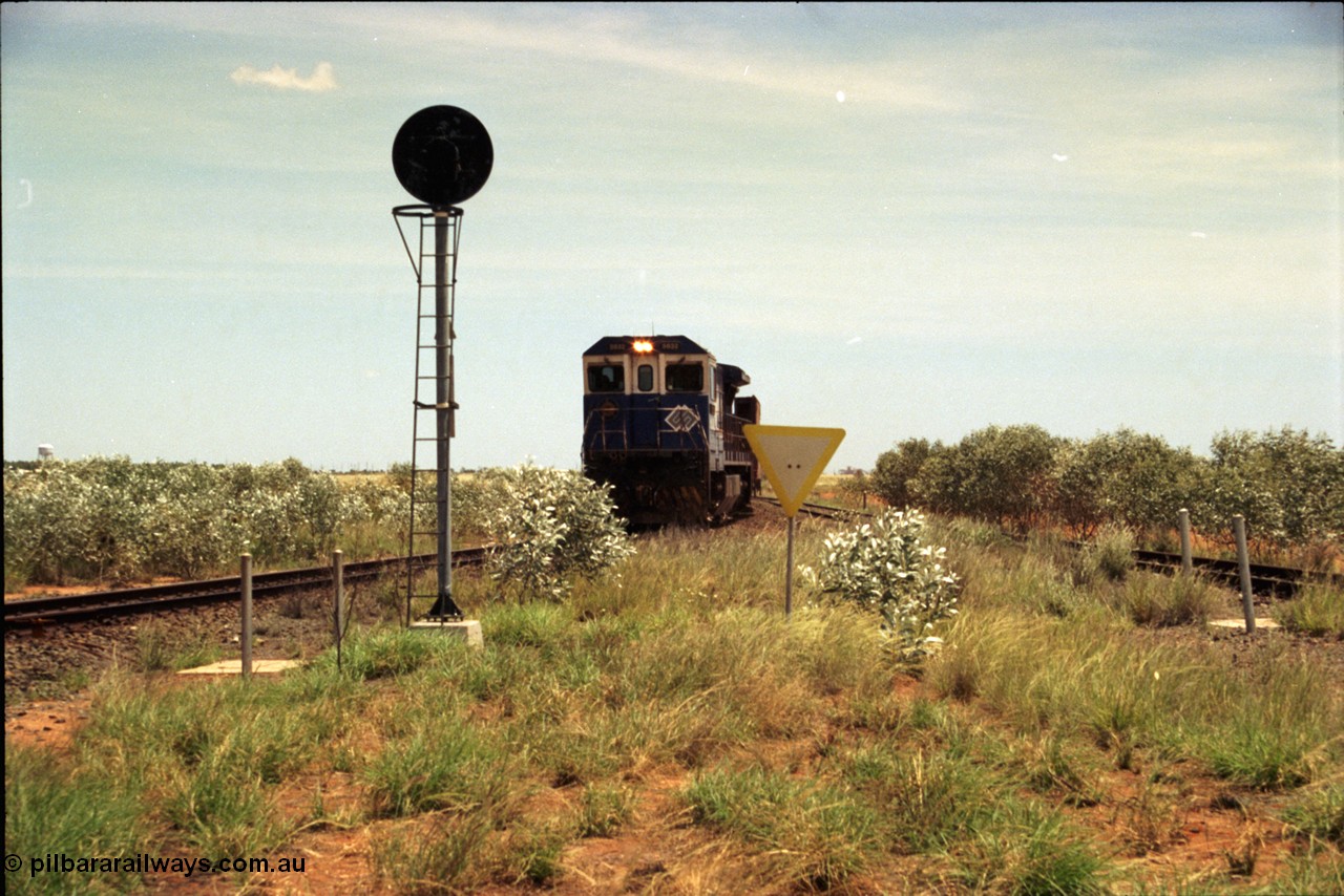 197-04
Goldsworthy Junction, looking west with the end of the triangle or wye, signal post is GJ 7, empty iron ore train behind BHP's Goninan 1988 build GE CM39-8 unit 5632 'Poseidon' serial 5831-11 / 88-081.
Keywords: 5632;Goninan;GE;CM39-8;5831-11/88-081;