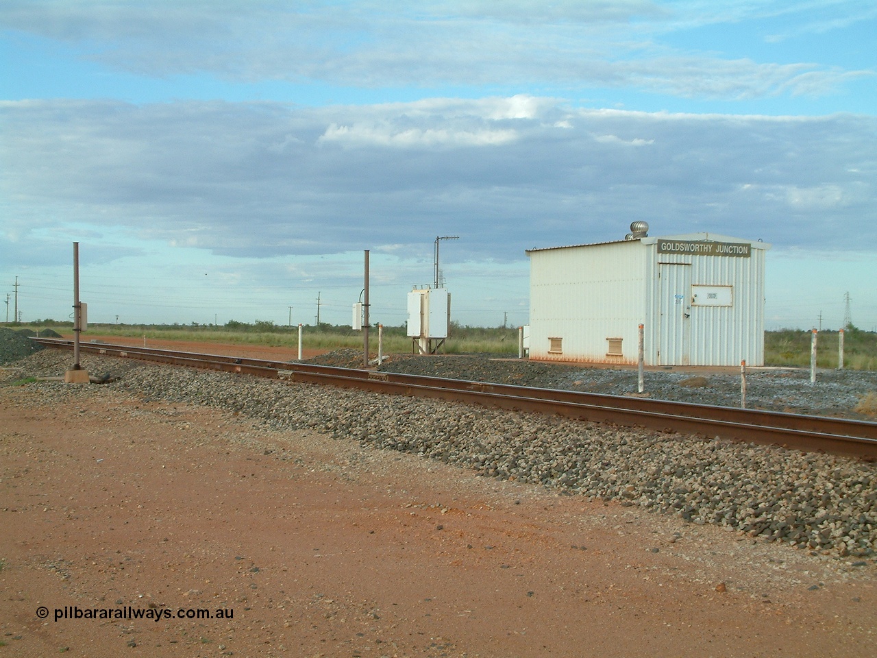 040407 072053
Goldsworthy Junction, looking south west, relay room with RFID readers on the post, also the site of the in-motion weighbridge. This was the single track section between both sets of switches for the Goldsworthy line to join and cross the Newman line. 7th April 2004.
