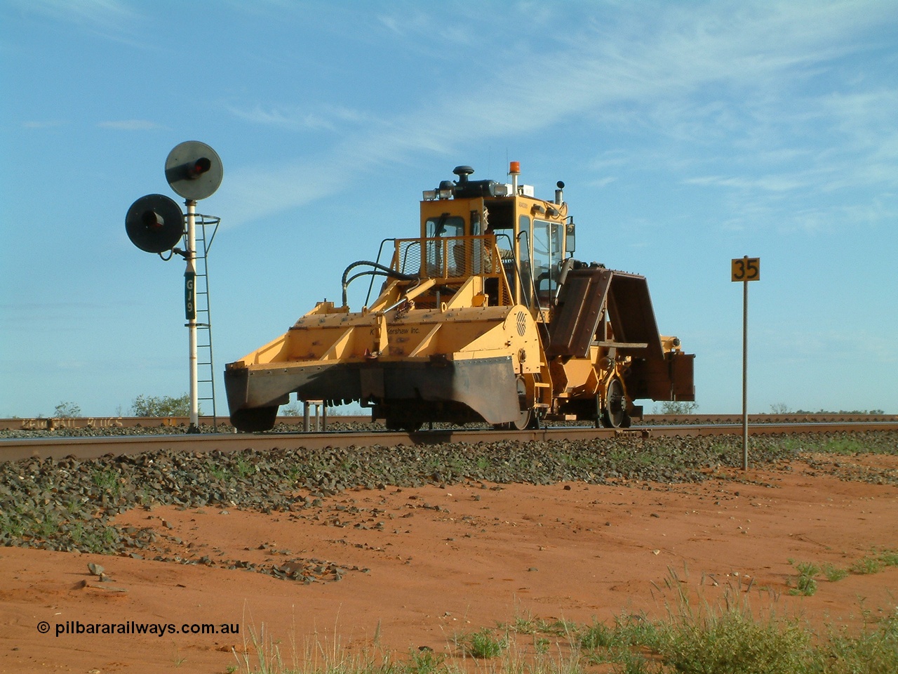 040407 073324
Goldsworthy Junction, Barclay Mowlem's R.E.L.A.M lease ballast plough, Knox Kershaw KBR 850 model travels east along the Goldsworthy line past the dual headed GJ 9 signal. 7th April 2004
Keywords: Knox-Kershaw;KBR-850;track-machine;