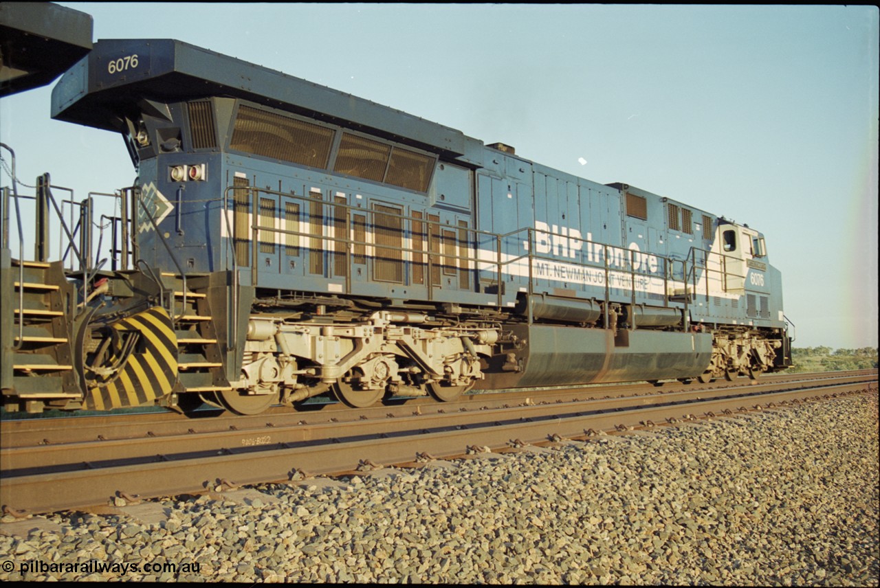 203-09
Bing Siding, BHP General Electric built AC6000 unit 6076 'Mt Goldsworthy' serial 51068 in the passing track with a Yandi empty working. The size of the BHP AC6000 model radiator is clearly evident here.
Keywords: 6076;GE;AC6000;51068;