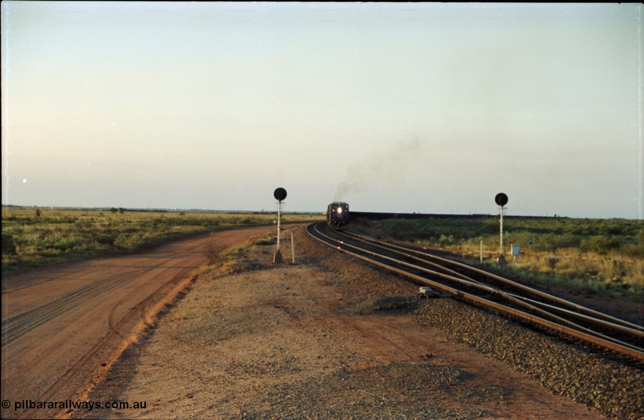 203-16
Bing Siding, with the empty clear, BHP General Electric AC6000 unit 6076 'Mt Goldsworthy' serial 51068 powers its' train out of the passing track at Bing South.
Keywords: 6076;GE;AC6000;51068;