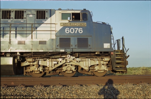 203-12
Bing Siding, BHP Iron Ore General Electric AC6000 model 6076 'Mt Goldsworthy' serial 51068 with an empty train. Cab side view with name board, steerable bogie and Driver Cosgrove at the controls.
Keywords: 6076;GE;AC6000CW;51068;