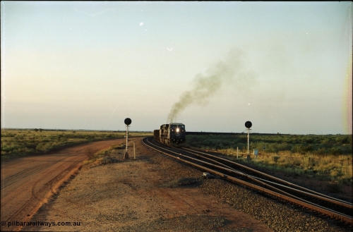 203-17
Bing Siding, with the empty clear, BHP General Electric AC6000 unit 6076 'Mt Goldsworthy' serial 51068 powers its' train out of the passing track at Bing South.
Keywords: 6076;GE;AC6000CW;51068;
