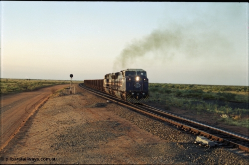 203-19
Bing Siding, with the empty clear, BHP General Electric AC6000 unit 6076 'Mt Goldsworthy' serial 51068 powers its' train out of the passing track at Bing South.
Keywords: 6076;GE;AC6000CW;51068;