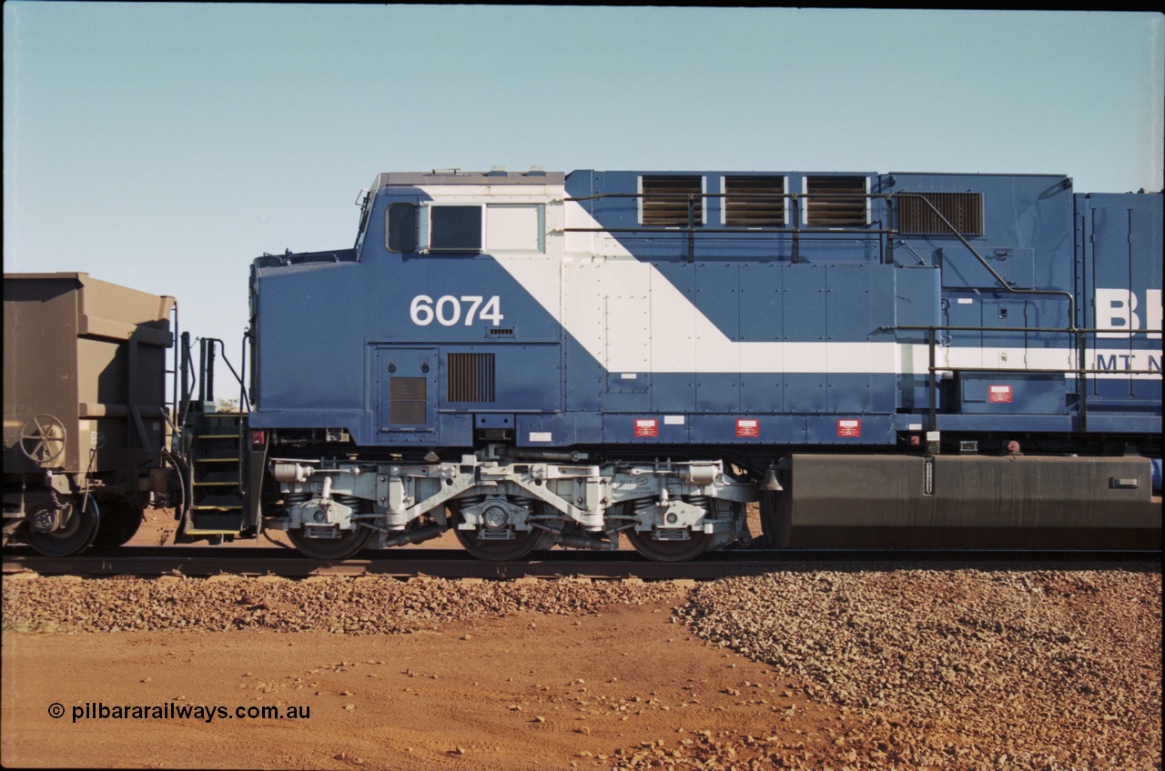 207-11
BHP General Electric built AC6000 unit 6074 serial 51066, brand new and unnamed at Yandi One load-out loop as a remote mid-train unit, view of the left hand side cab and steerable bogie.
Keywords: 6074;GE;AC6000;51066;