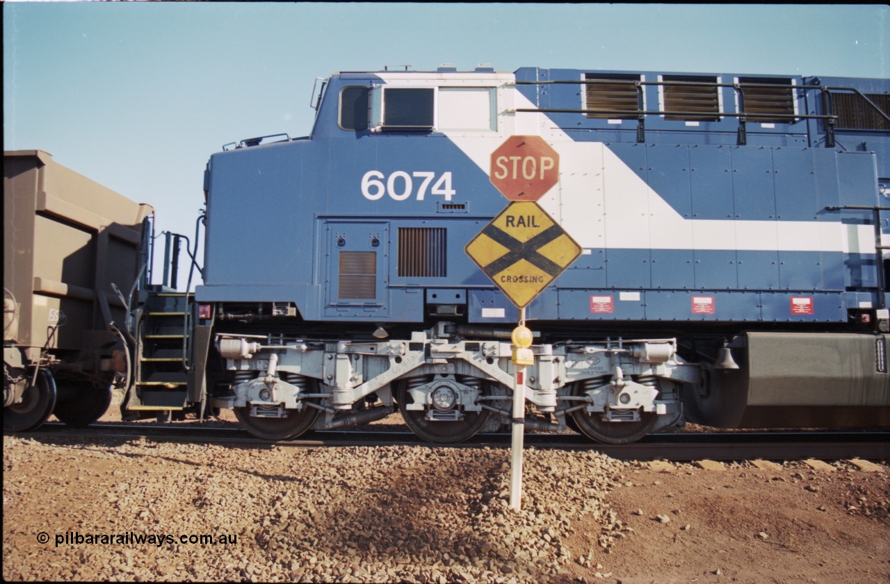 207-14
BHP General Electric built AC6000 unit 6074 serial 51066, brand new and unnamed at Yandi One load-out loop as a remote mid-train unit, view of the left hand side cab and steerable bogie.
Keywords: 6074;GE;AC6000;51066;