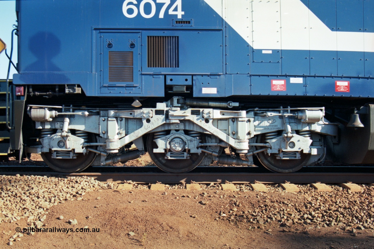 207-15
BHP General Electric built AC6000 unit 6074 serial 51066, brand new and unnamed at Yandi One load-out loop as a remote mid-train unit, view of the left hand side steerable bogie.
Keywords: 6074;GE;AC6000;51066;