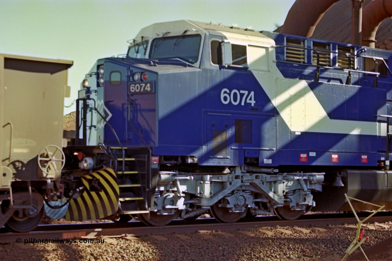 207-17
BHP General Electric built AC6000 unit 6074 serial 51066, brand new and unnamed at Yandi One load-out loop as a remote mid-train unit, view of the left hand side cab and steerable bogie.
Keywords: 6074;GE;AC6000;51066;