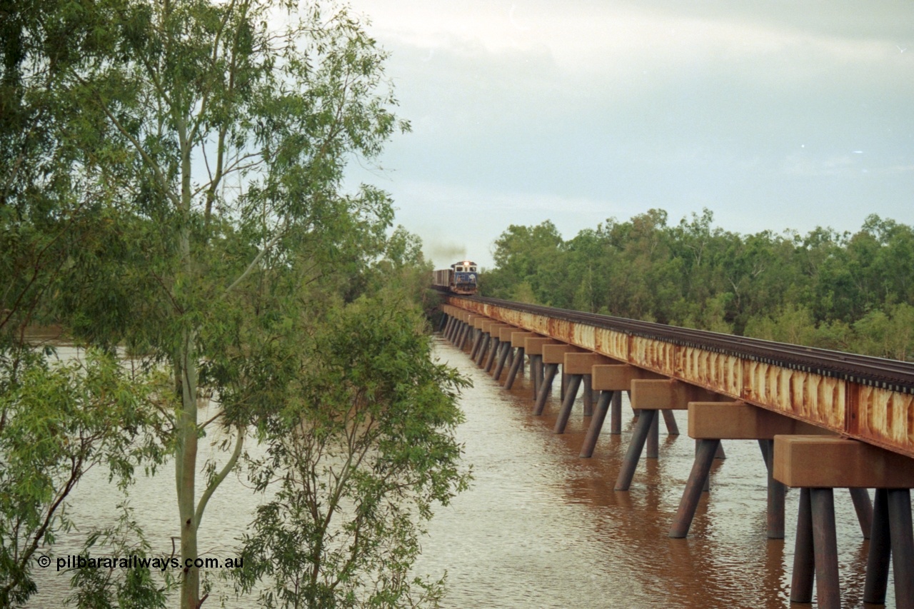 218-07
De Grey River Bridge, a loaded Yarrie train crosses the river behind an original Mt Newman Mining ALCo to GE rebuild carried out by Goninan, originally ALCo C636 5458 to GE model C36-7M unit 5510 'Newman' serial 4839-07 / 87-075.
Keywords: 5510;Goninan;GE;C36-7M;4839-07/87-075;rebuild;AE-Goodwin;ALCO;C636;5458;G6027-2;