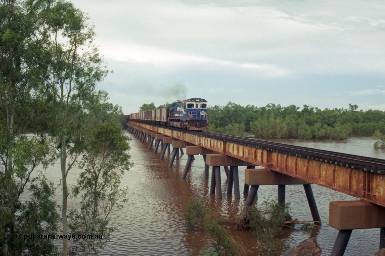 218-10
De Grey River Bridge, a loaded Yarrie train crosses the river behind an original Mt Newman Mining ALCo to GE rebuild carried out by Goninan, originally ALCo C636 5458 to GE model C36-7M unit 5510 'Newman' serial 4839-07 / 87-075.
Keywords: 5510;Goninan;GE;C36-7M;4839-07/87-075;rebuild;AE-Goodwin;ALCO;C636;5458;G6027-2;