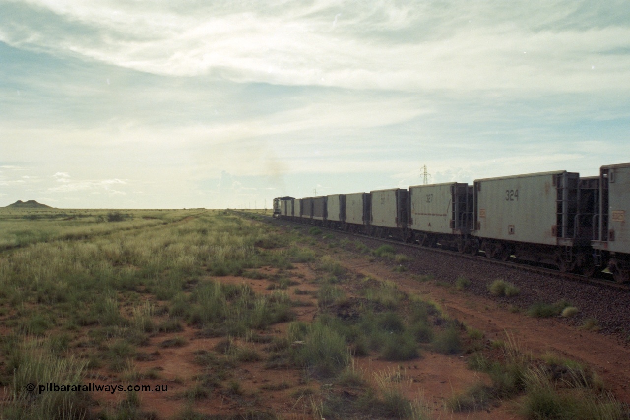 218-25
De Grey, Great Northern Highway grade crossing at the 57.15 km a loaded GML train with Gunderson USA (smooth) and Portec USA (ribbed) built waggon behind the C36-7M loco. The waggons are ex-Phelps Dodge Copper Mine.
