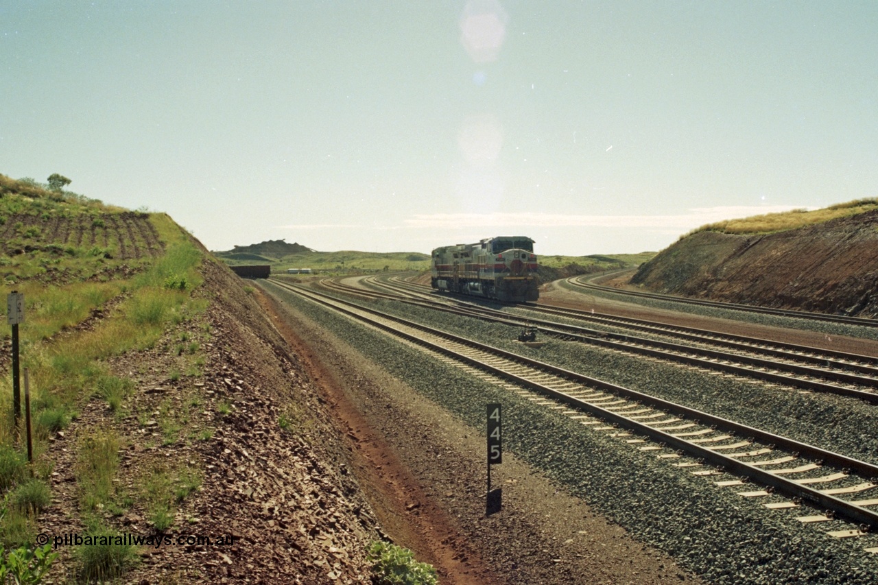 218-37
Yandicoogina or HIY as Hamersley Iron identify it, located 445 km from Parker Point yard in Dampier. Bank engine units General Electric Dash 9-44CW models 7089 serial 47768 and 7090 wait their next loaded train to push out, the tail of which is visible on the left with the mine stockpile in the background.
Keywords: 7090;GE;Dash-9-44CW;47769;