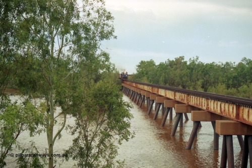 218-06
De Grey River Bridge, a loaded Yarrie train crosses the river behind an original Mt Newman Mining ALCo to GE rebuild carried out by Goninan, originally ALCo C636 5458 to GE model C36-7M unit 5510 'Newman' serial 4839-07 / 87-075.
Keywords: 5510;Goninan;GE;C36-7M;4839-07/87-075;rebuild;AE-Goodwin;ALCO;C636;5458;G6027-2;