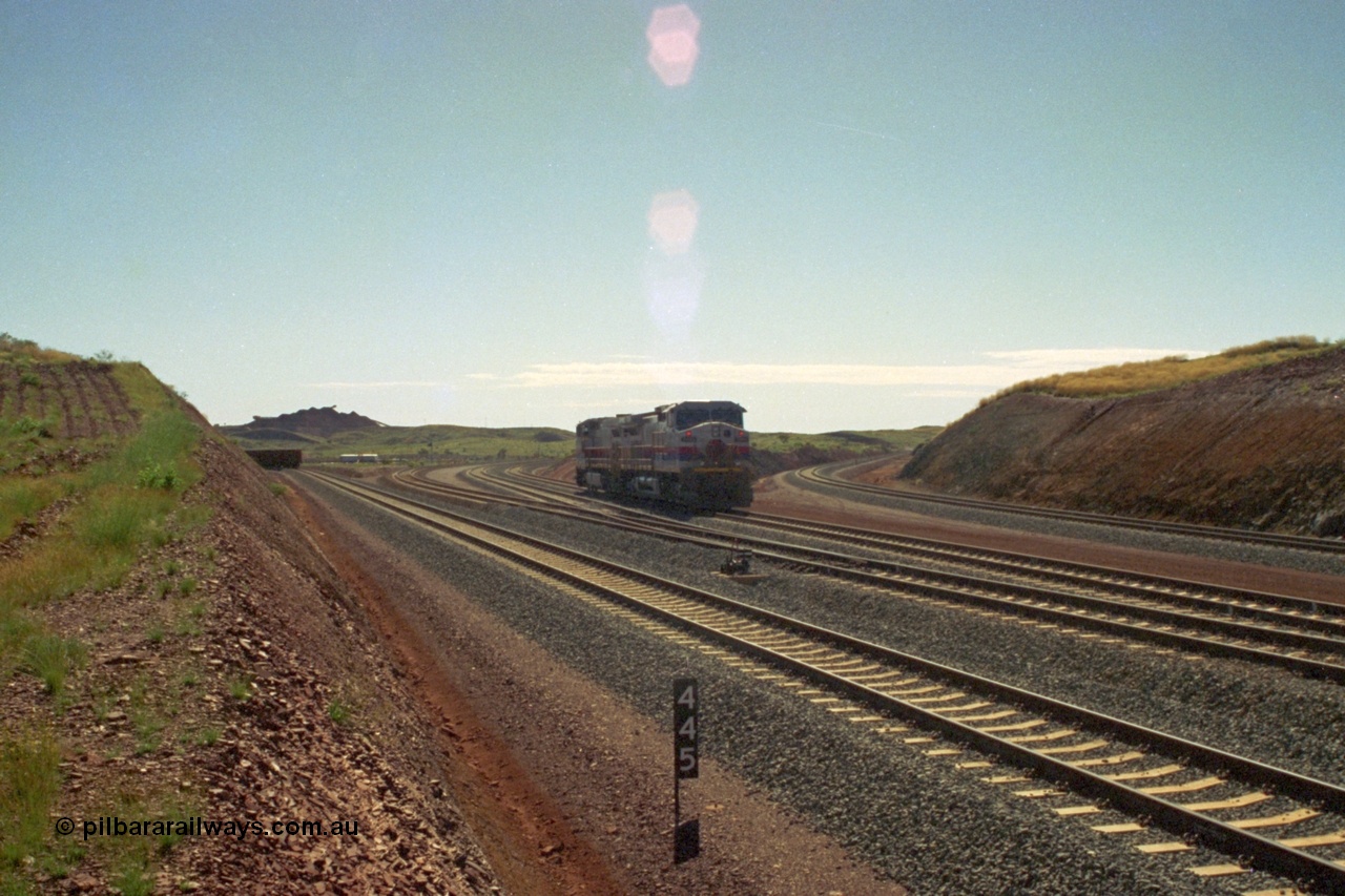 219-02
Yandicoogina or HIY as Hamersley Iron identify it, located 445 km from Parker Point yard in Dampier. Bank engine units General Electric Dash 9-44CW models 7089 serial 47768 and 7090 wait their next loaded train to push out, the tail of which is visible on the left with the mine stockpile in the background.
Keywords: 7089;GE;Dash-9-44CW;47768;