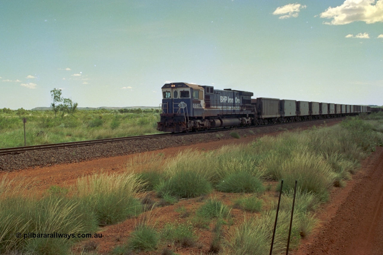 219-20
Goldsworthy Siding, C36-7M unit 5507 'Nimingarra' serial 4839-03 / 87-072, an original Mt Newman Mining ALCo C636 5461 to GE C36-7M rebuild carried out by Goninan, leads an empty train, the waggon behind 5507 is numbered 352 and is one of ten Portec USA built waggons originally from Phelps Dodge Copper Mine.
Keywords: 5507;Goninan;GE;C36-7M;4839-03/87-072;rebuild;AE-Goodwin;ALCo;C636;5461;G6035-2;