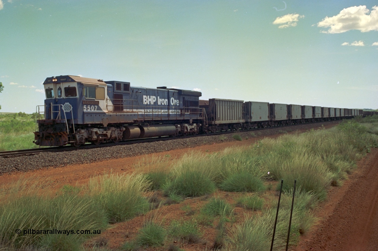 219-21
Goldsworthy Siding, C36-7M unit 5507 'Nimingarra' serial 4839-03 / 87-072, an original Mt Newman Mining ALCo C636 5461 to GE C36-7M rebuild carried out by Goninan, leads an empty train at Goldsworthy, the waggon behind 5507 is numbered 352 and is one of ten Portec USA built waggons originally from Phelps Dodge Copper Mine.
Keywords: 5507;Goninan;GE;C36-7M;4839-03/87-072;rebuild;AE-Goodwin;ALCo;C636;5461;G6035-2;