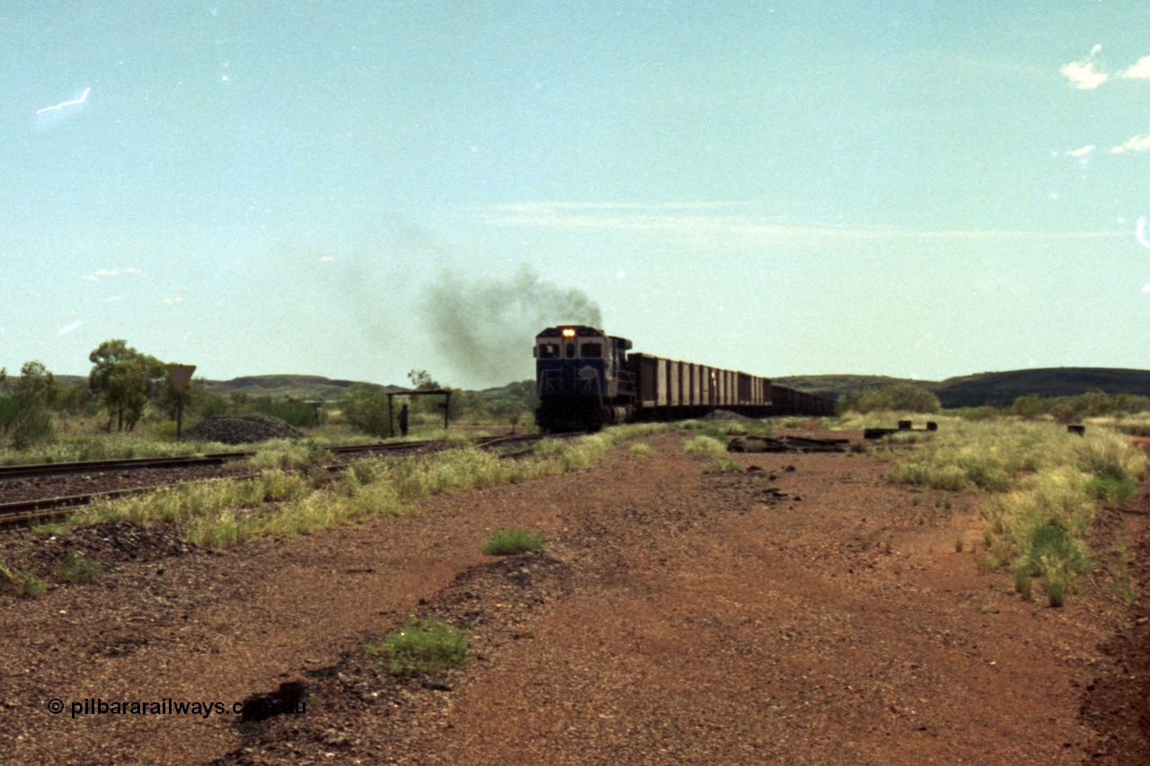 219-26
Goldsworthy Siding, C36-7M unit 5507 'Nimingarra' serial 4839-03 / 87-072, an original Mt Newman Mining ALCo C636 5461 to GE C36-7M rebuild carried out by Goninan, leads an empty train into the siding at Goldsworthy as the second driver watches the roll by under the shelter.
Keywords: 5507;Goninan;GE;C36-7M;4839-03/87-072;rebuild;AE-Goodwin;ALCo;C636;5461;G6035-2;