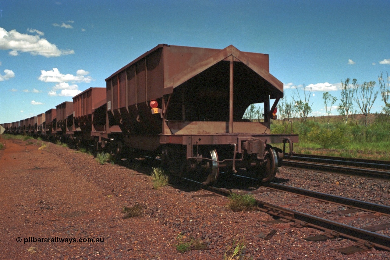 219-32
Goldsworthy Siding, the rear of an empty train sits in the siding awaiting a meet. The waggons in view were designed by AE Goodwin and built by Scott's of Ipswich and Tomlinson Steel Perth.
Keywords: Tomlinson-Steel-WA;BHP-ore-waggon;