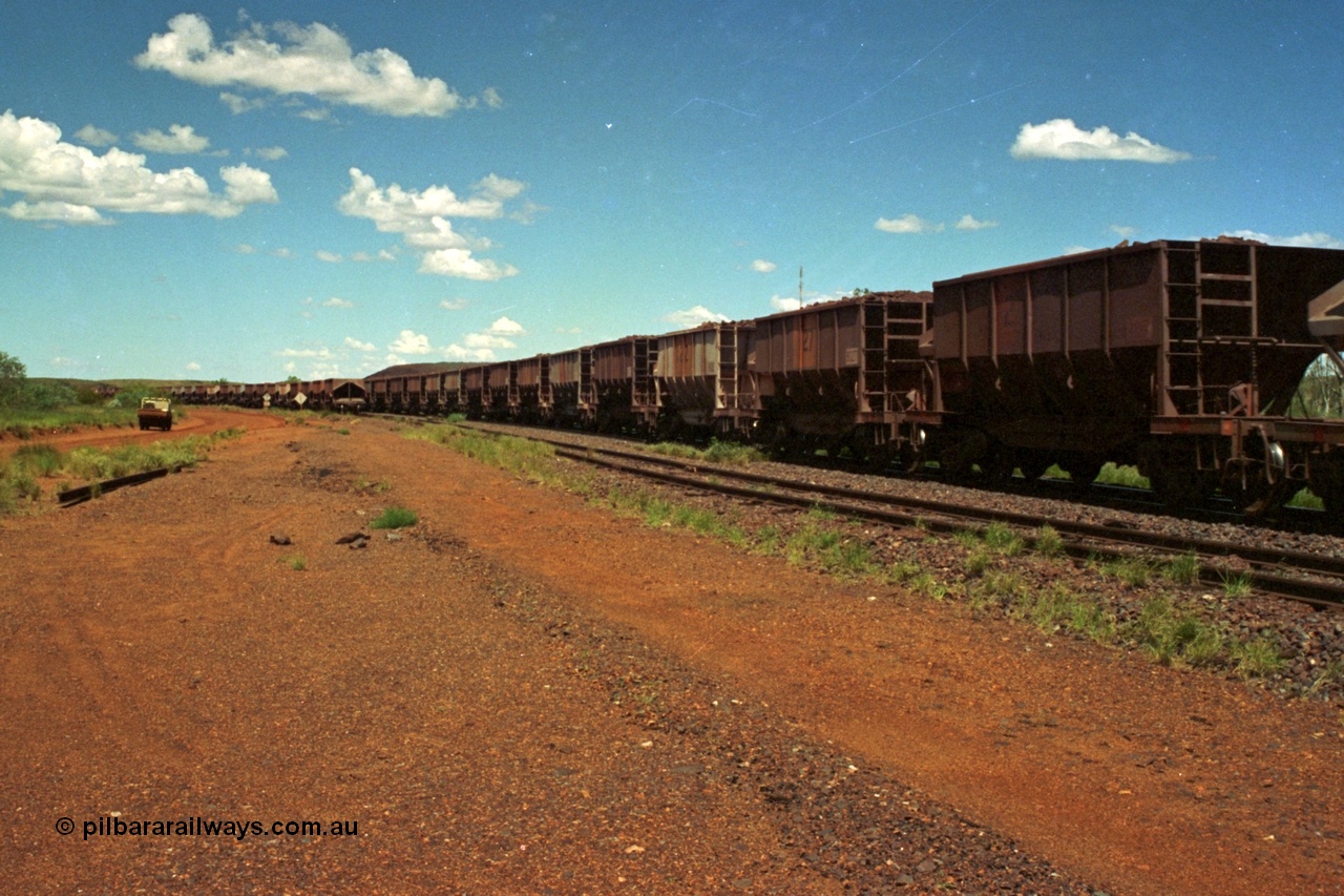 219-36
Goldsworthy Siding, loaded train running along the mainline with Scotts of Ipswich and Tomlinson Steel Perth built waggons of an AE Goodwin design.
