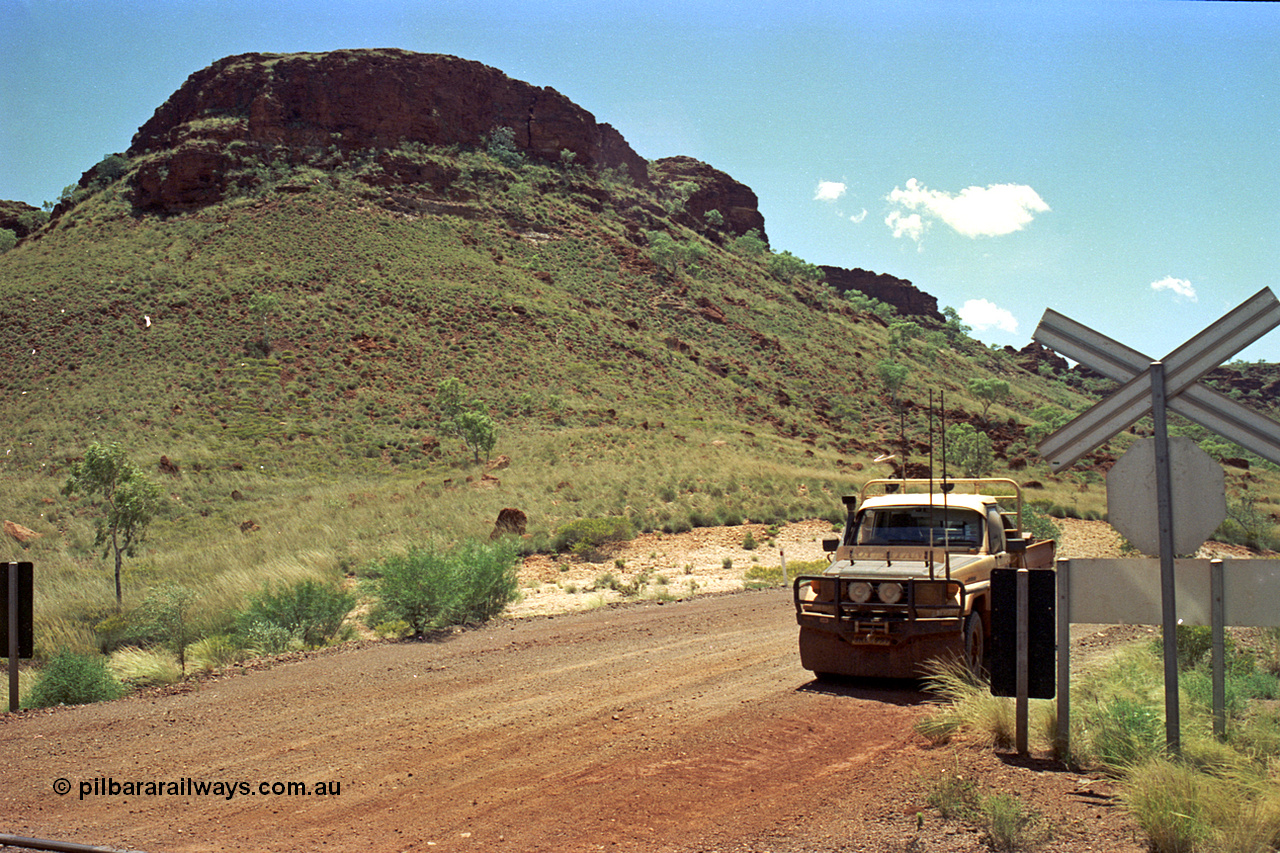 220-12
Shay Gap, Mable Bar Rd grade crossing at the 187.6 km on the line to Yarrie, hills, Toyota HJ75 Landcruiser.
