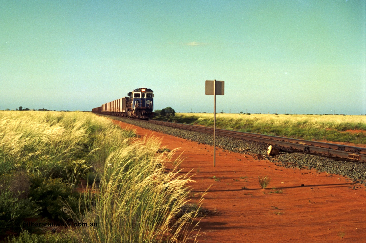 220-22
Goldsworthy Junction, a loaded train from Yarrie mine lead by BHP Dash 7 unit 5507 'Nimingarra' serial 4839-03 / 87-072 was rebuilt by Goninan WA from an ALCo C636 unit 5461 into GE model C36-7M in 1987.
Keywords: 5507;Goninan;GE;C36-7M;4839-03/87-072;rebuild;AE-Goodwin;ALCo;C636;5461;G6035-2;