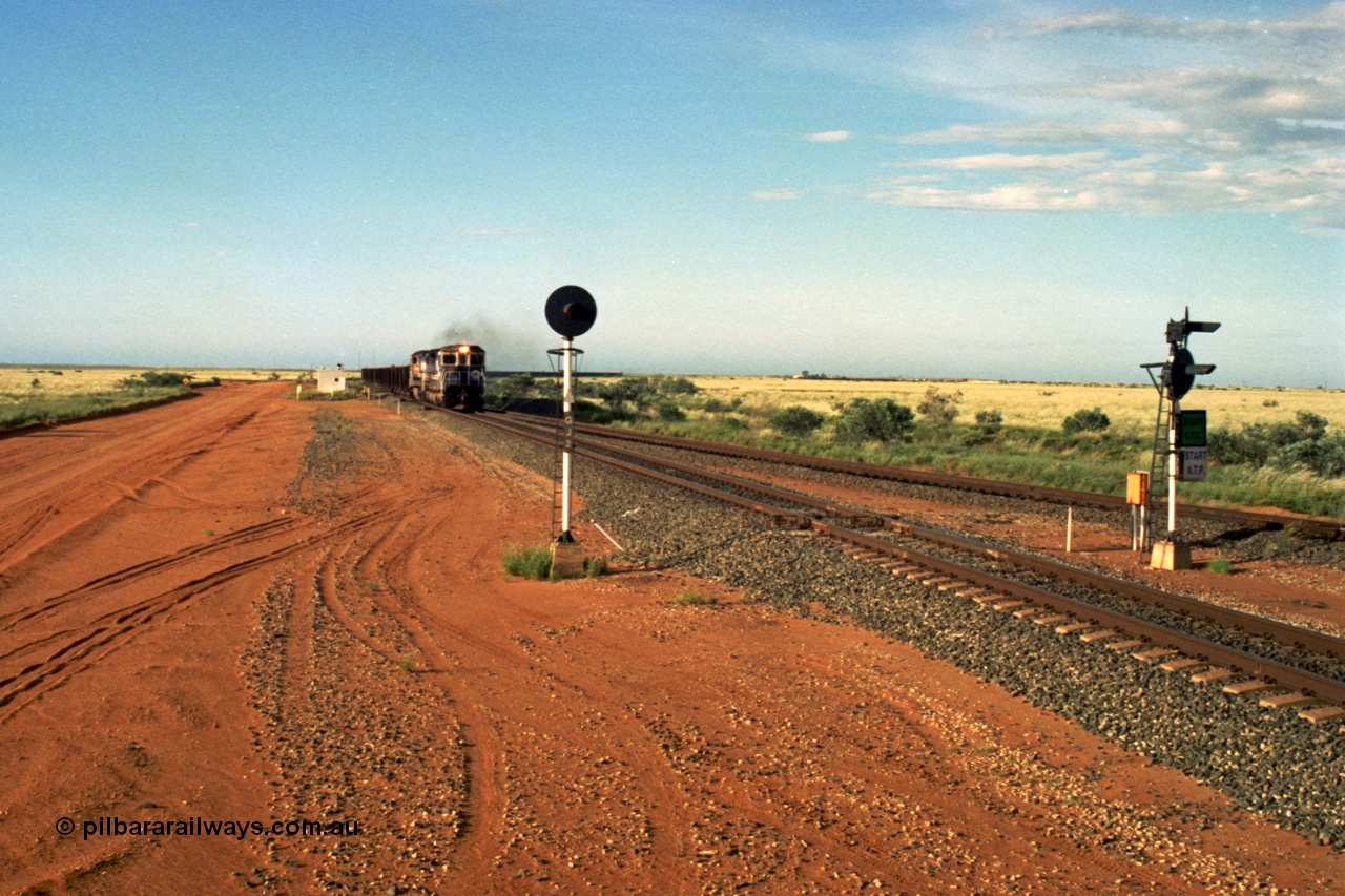 220-30
Goldsworthy Junction, the afternoon empty departure for Yandi mine behind the standard double Dash 8 power consist of 5649 'Pohang' a Goninan GE rebuild CM40-8M model serial 8412-07 / 93-140 and a sister unit, the line merging from the right is the former Goldsworthy line from Yarrie and Nimingarra mines. This area is now fully duplicated with LED signals and the Dash 8 units have been scrapped.
Keywords: 5649;Goninan;GE;CM40-8M;8412-07/93-140;rebuild;AE-Goodwin;ALCo;M636C;5473;G6047-5;