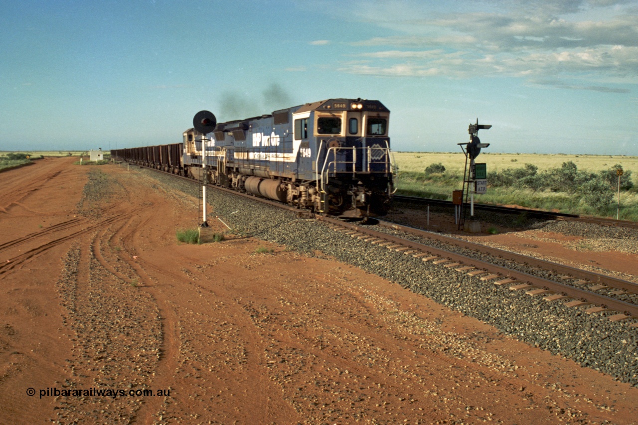 220-31
Goldsworthy Junction, the afternoon empty departure for Yandi mine behind the standard double Dash 8 power consist of 5649 'Pohang' a Goninan GE rebuild CM40-8M model serial 8412-07 / 93-140 and a sister unit as the split the sticks, the line merging from the right is the former Goldsworthy line from Yarrie and Nimingarra mines. This area is now fully duplicated with LED signals and the Dash 8 units have been scrapped.
Keywords: 5649;Goninan;GE;CM40-8M;8412-07/93-140;rebuild;AE-Goodwin;ALCo;M636C;5473;G6047-5;