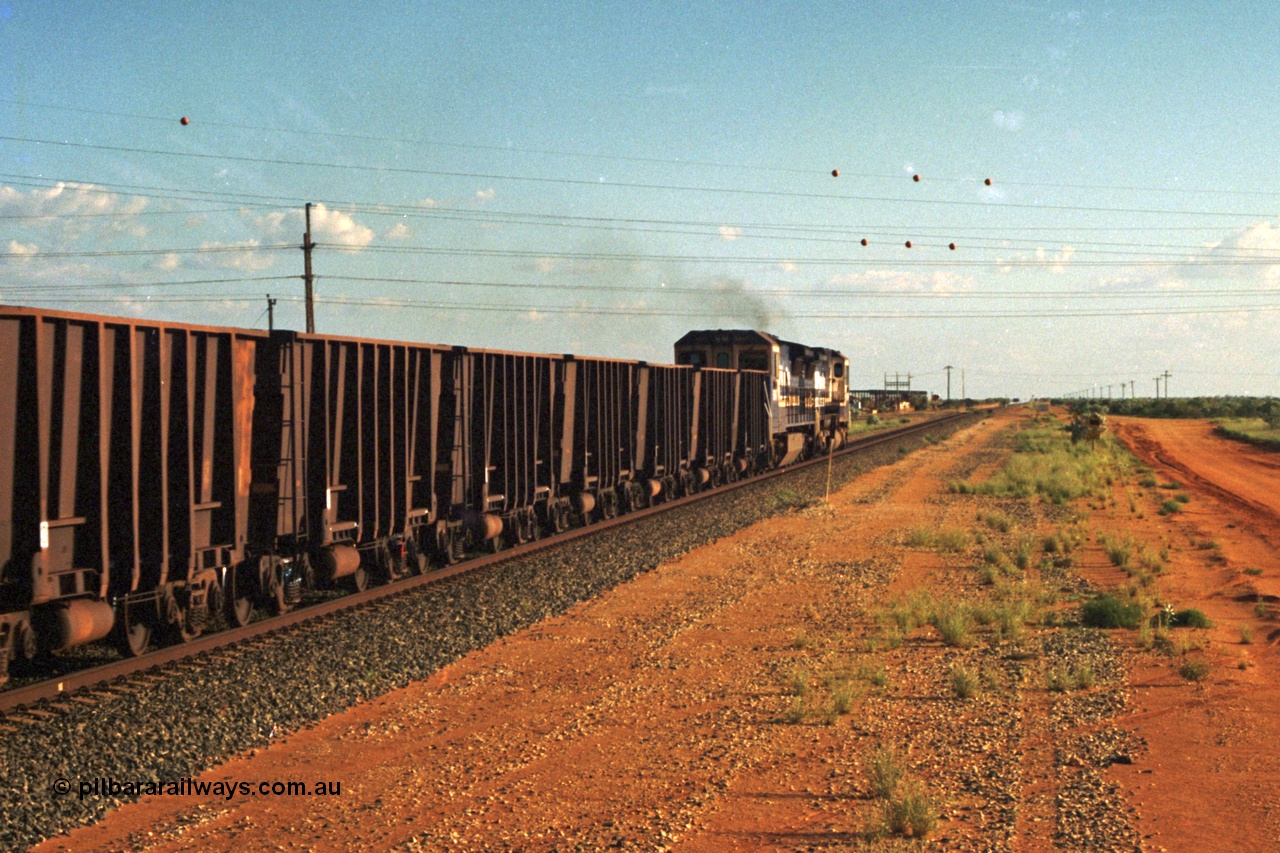 220-32
Goldsworthy Junction, trailing shot of the afternoon departure for Yandi mine behind the standard double Dash 8 power consist, heading towards Bing Siding with the Flashbutt Yard visible in the distance.
