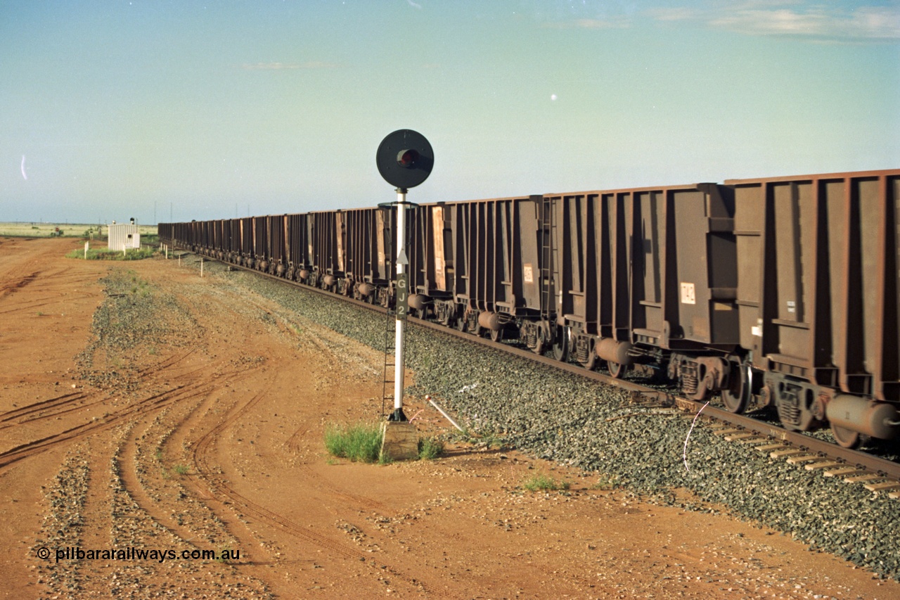 220-33
Goldsworthy Junction, an empty train rolls through the Junction on the Newman Mainline with mostly Comeng WA style built waggons and the odd Goninan one. This area is now fully duplicated.
