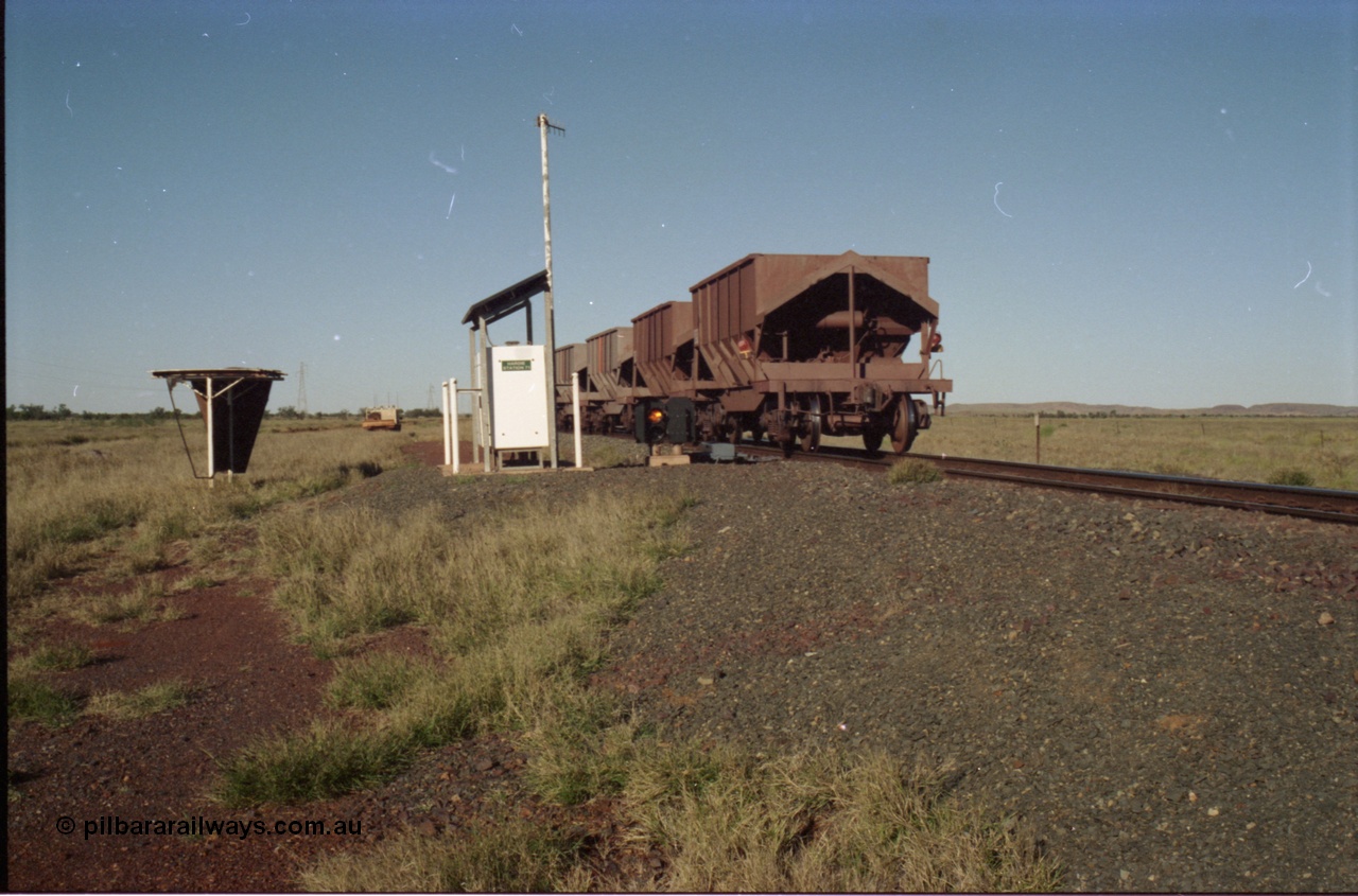 221-11
Hardie Siding, with the switch now set for the siding, the empty train is reversing out back onto the mainline, the ore cars are Tomlinson Steel built bottom discharge units. Note the end of train device are two flashing red lights, and no digitair.
