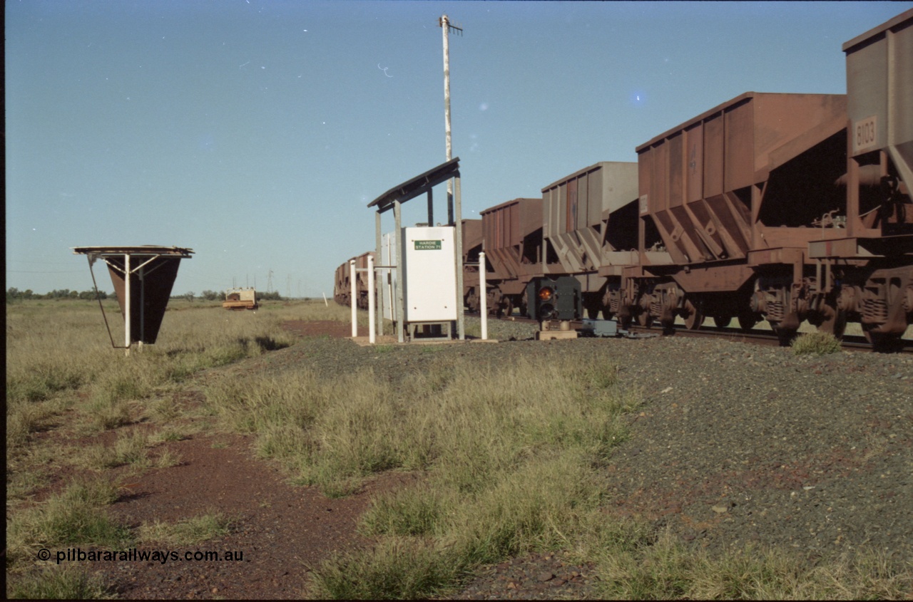 221-12
Hardie Siding, with the switch now set for the siding, the empty train is reversing out back onto the mainline, the ore cars are Tomlinson Steel built bottom discharge units.
