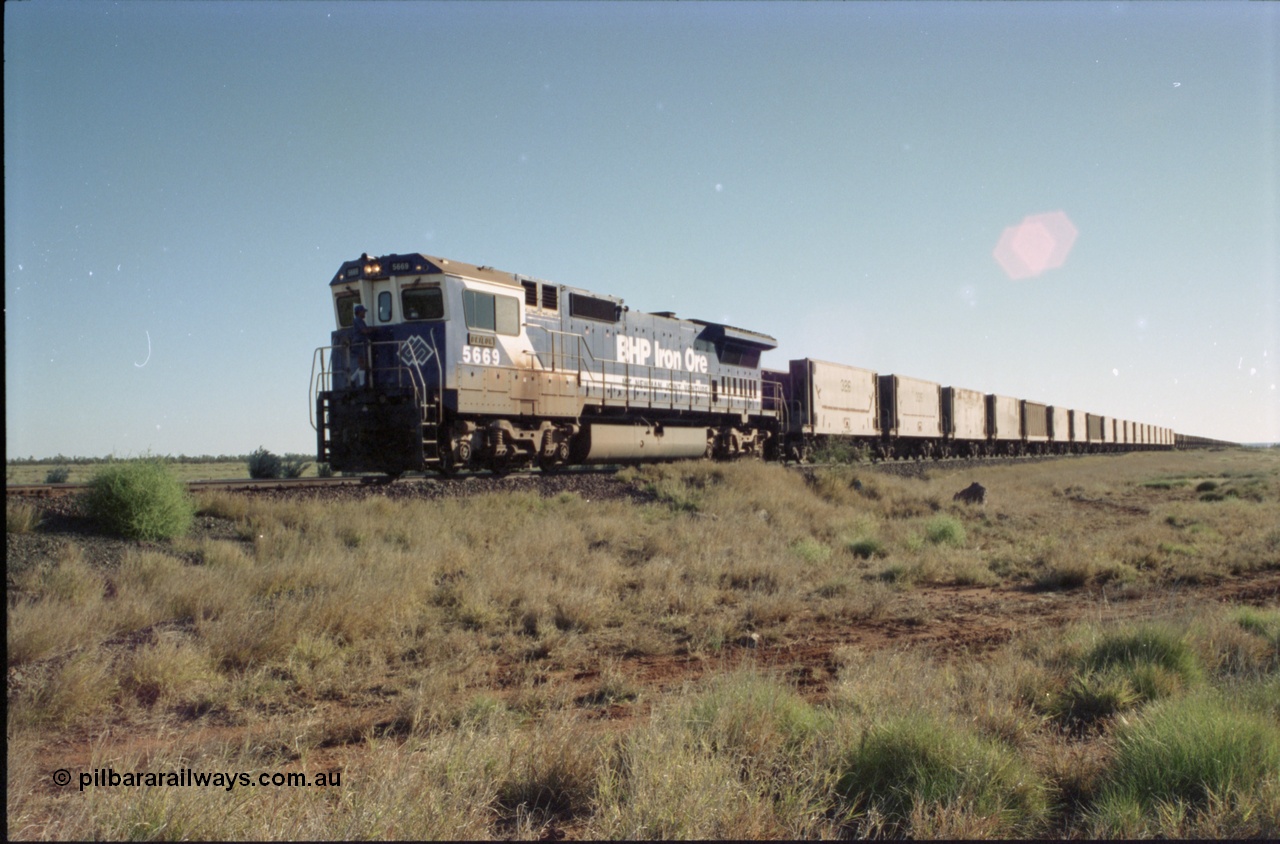 221-15
Hardie Siding, BHP Iron Ore Goninan rebuild unit CM40-8MEFI 5669 the last Dash 8 rebuilt for BHP and one of four fitted with an EFI prime mover, serial 95-160/8412-02, with the switch restored for the mainline the 2nd Person climbs aboard to continue on to Yarrie Mine.
Keywords: 5669;Goninan;GE;CM40-8EFI;8412-02/95-160;rebuild;Comeng-NSW;ALCo;M636C;5486;C6084-2;