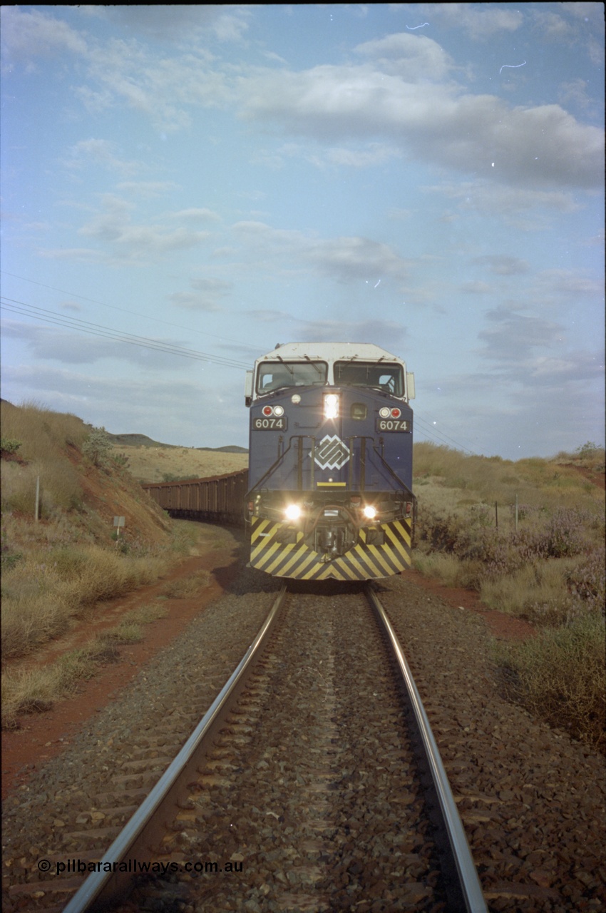 221-37
Yandi One mine loadout balloon loop, front on view of near new General Electric AC6000 unit 6074 serial 51066 as it loads a train.
Keywords: 6074;GE;AC6000;51066;