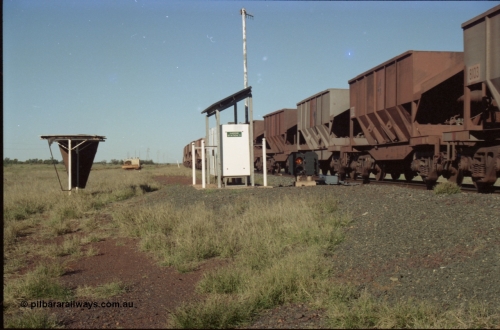 221-12
Hardie Siding, with the switch now set for the siding, the empty train is reversing out back onto the mainline, the ore cars are Tomlinson Steel built bottom discharge units.
