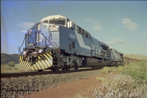 221-34
Yandi One mine loadout balloon loop, near new General Electric AC6000 unit 6074 serial 51066 leads sister unit 6071 serial 51063 at the Y312.1 km crossing while controlling a train being loaded.
Keywords: 6074;GE;AC6000CW;51066;