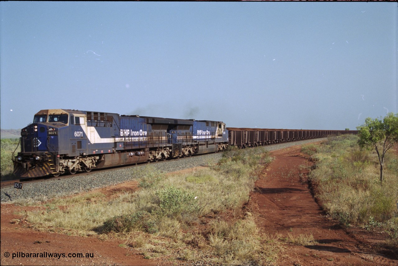 222-03
At the 105.7 km grade crossing near Gillam Siding, a loaded Yandi train approaches behind two General Electric AC6000 units built by GE at their Erie plant, BHP 6071 serial 51063 leads sister unit 6074, 6071 has not been named as yet. This road was also the original road into Lynas Find Gold Project, back in the day. [url=https://goo.gl/maps/7emwhQdnBN32]GeoData[/url].
Keywords: 6071;GE;AC6000;51063;