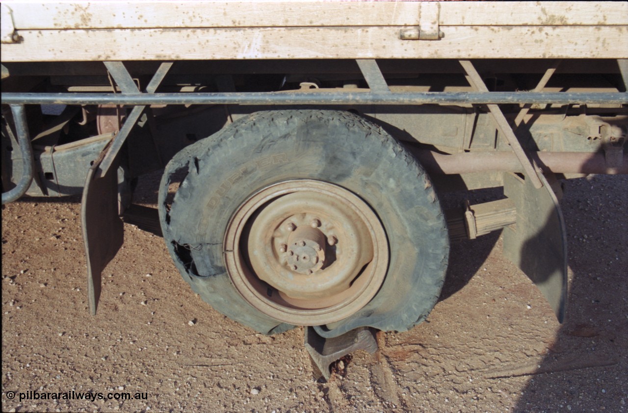 222-12
Flat tyre on the BHP access road, the off cut of rail is used to get the axle high enough to fit the factory jack under it, Oh What a Feeling…
