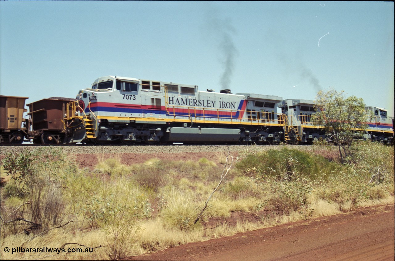 222-29
Somewhere on the original single line section between Gull and Rosella Hamersley Iron 7073 serial 47752 a General Electric Dash 9-44CW built by GE at Erie powers away with an empty train with 7091 following a crew change with a loaded train.
Keywords: 7073;GE;Dash-9-44CW;47752;