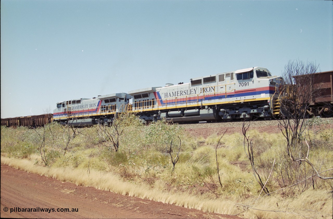 222-30
Somewhere on the original single line section between Gull and Rosella Hamersley Iron 7073 serial 47752 a General Electric Dash 9-44CW built by GE at Erie powers away with an empty train with sister Dash 9-44CW unit 7091 serial 47770 following a crew change with a loaded train.
Keywords: 7091;GE;Dash-9-44CW;47770;