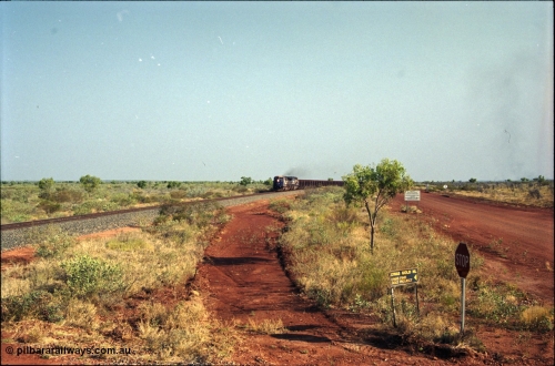 222-01
At the 105.7 km grade crossing near Gillam Siding, a loaded Yandi train approaches behind two General Electric AC6000 units built by GE at their Erie plant. This road was also the original road into Lynas Find Gold Project, back in the day. [url=https://goo.gl/maps/7emwhQdnBN32]GeoData[/url].
