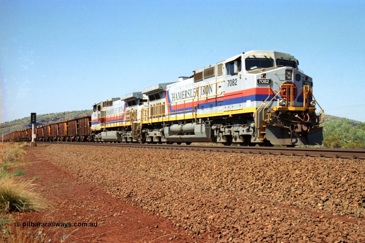 223-13
Possum Siding, Hamersley Iron loco 7082 a General Electric built Dash 9-44CW serial 47761 leads sister unit 7080 with an empty train just inside the loop waiting to effect a crew change. 21st October 2000.
Keywords: 7082;GE;Dash-9-44CW;47761;