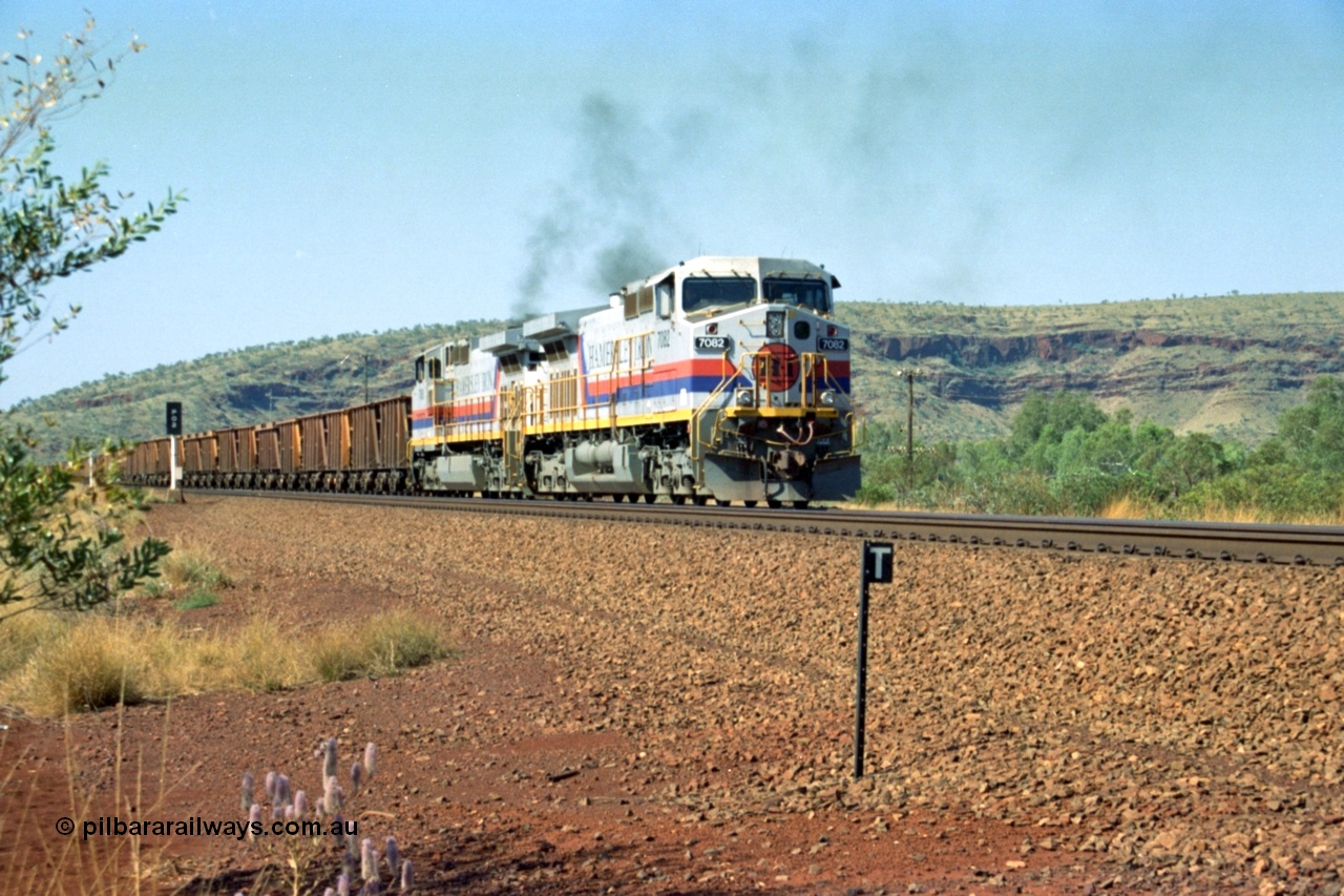 223-23
Possum Siding, Hamersley Iron loco 7082 a General Electric built Dash 9-44CW serial 47761 leads sister unit 7080 with an empty train as they power up to pull forward inside the loop to effect a crew change. 21st October 2000.
Keywords: 7082;GE;Dash-9-44CW;47761;