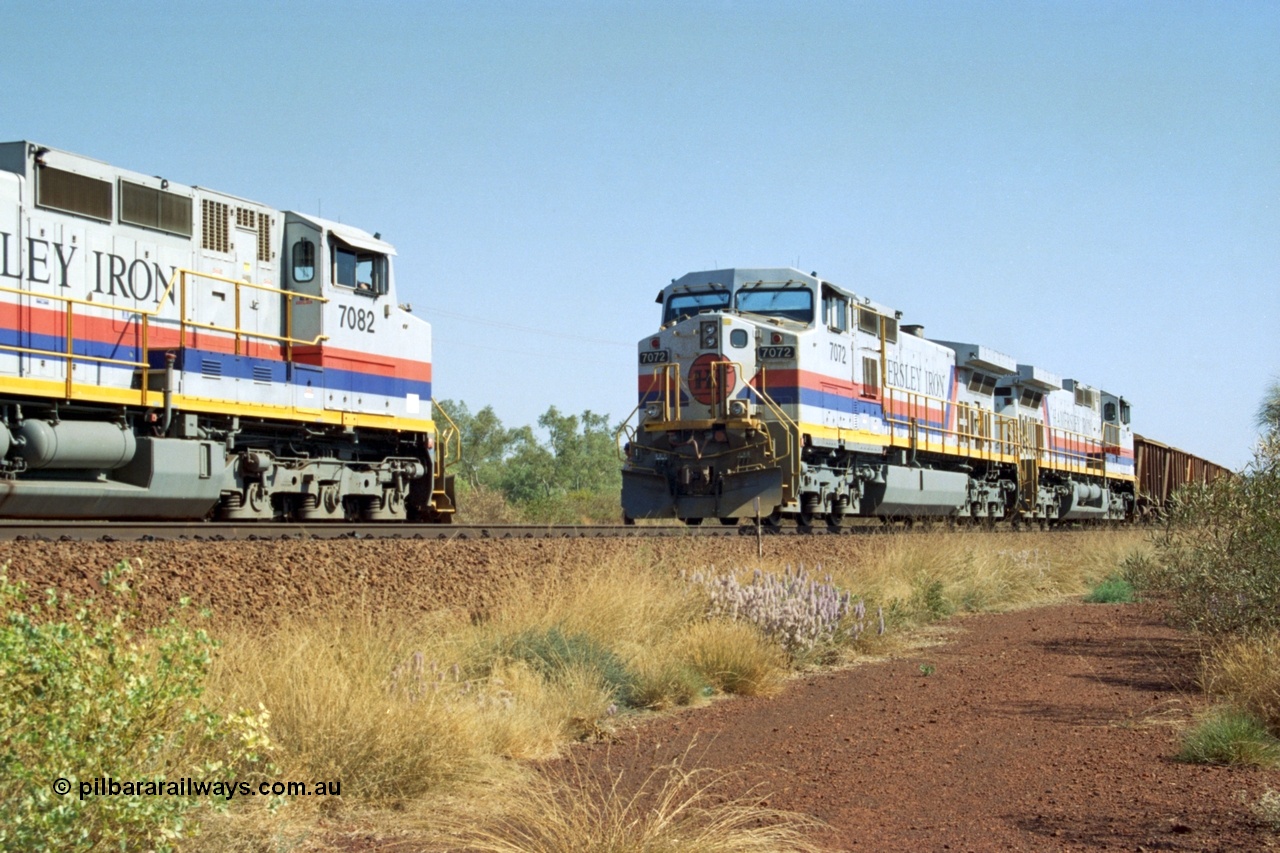 223-24
Possum Siding, Hamersley Iron locos built by General Electric model Dash 9-44CW units 7072 serial 47751 with 210 waggons loaded ex Marandoo changes crew with sister loco 7082 serial 47761 on an empty at 1500 hrs 21st October 2000.
Keywords: 7072;GE;Dash-9-44CW;47751;