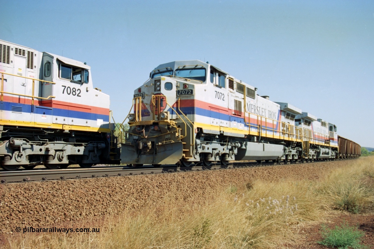 223-25
Possum Siding, Hamersley Iron locos built by General Electric model Dash 9-44CW units 7072 serial 47751 with 210 waggons loaded ex Marandoo changes crew with sister loco 7082 serial 47761 on an empty at 1500 hrs 21st October 2000.
Keywords: 7072;GE;Dash-9-44CW;47751;