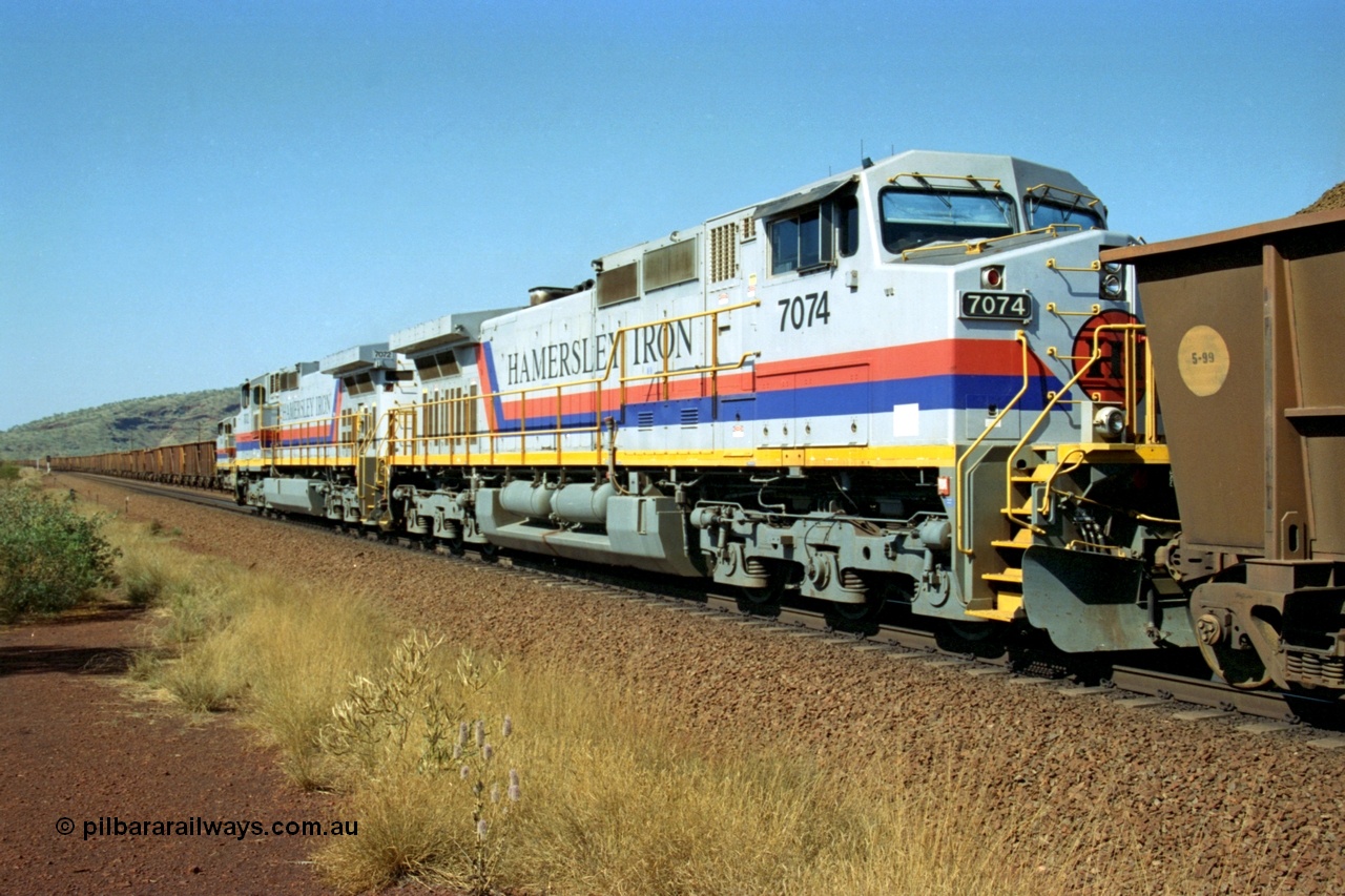 223-28
Possum Siding, trailing view of Hamersley Iron General Electric built Dash 9-44CW units 7072 in the lead and 7074 serial 47753 with a loaded train ex Marandoo having just completed a crew change with an empty train. 21st October 2000.
Keywords: 7074;GE;Dash-9-44CW;47753;