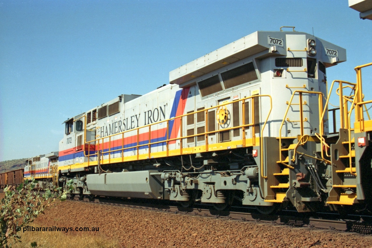 223-29
Possum Siding, rear view of Hamersley Iron loco 7072 a General Electric built Dash 9-44CW model serial 47751 leads sister unit 7074 with a loaded train as they effect a crew change. 21st October 2000.
Keywords: 7072;GE;Dash-9-44CW;47751;
