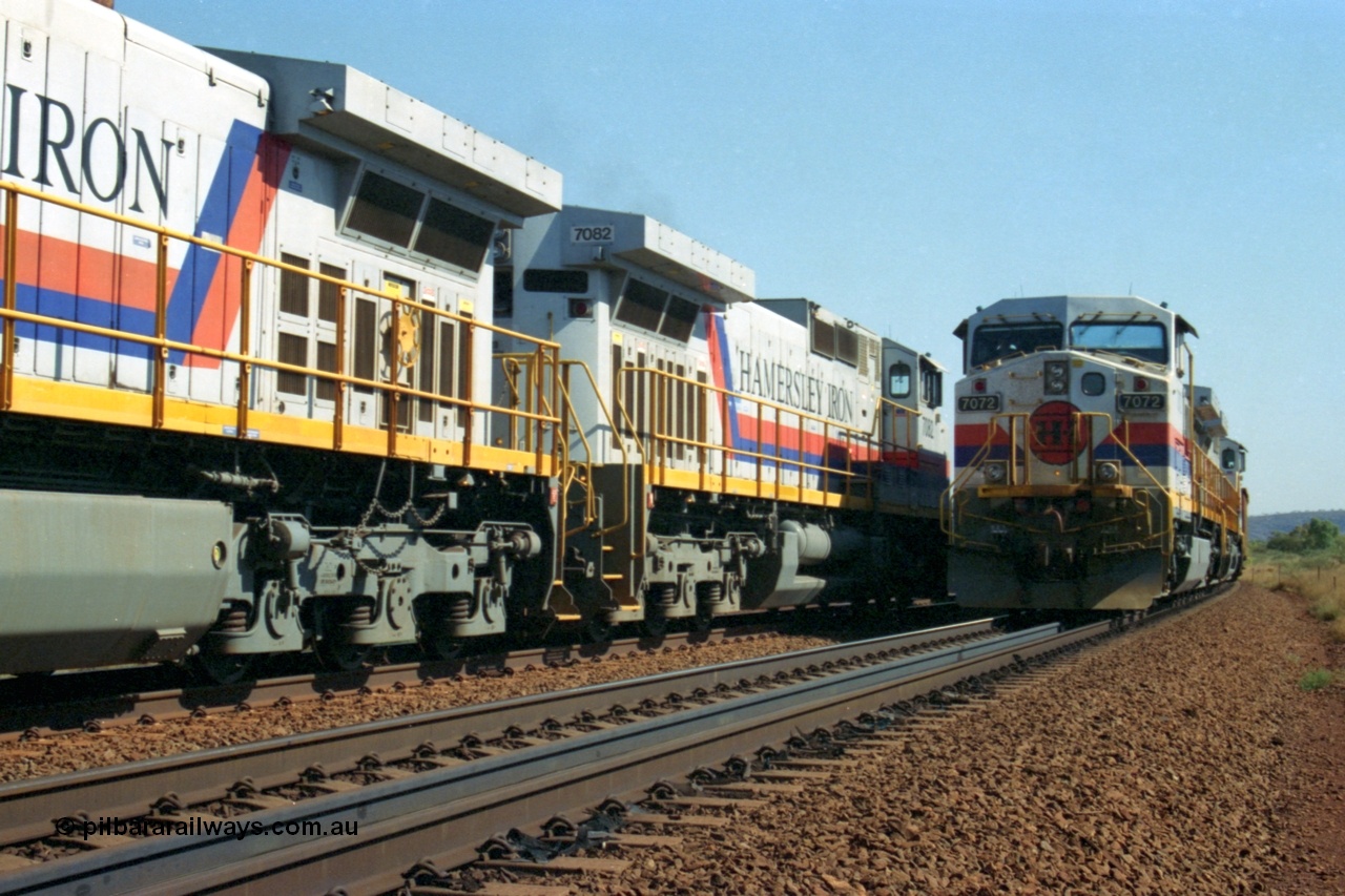 223-30
Possum Siding, a loaded train behind a pair of Hamersley Iron General Electric built Dash 9-44CW units 7072 serial 47751 and 7074 serial 47753 with the crew change completed, the empty is starting to roll on the passing track. 21st October 2000.
Keywords: 7072;GE;Dash-9-44CW;47751;